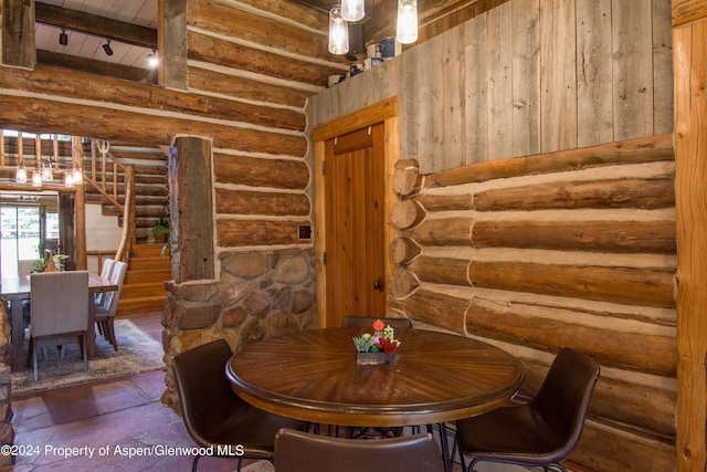 1150 Capitol Creek Rd, Snowmass, CO 81654 - dining space featuring log walls, a wood ceiling with exposed beams, and stairway