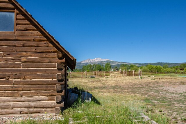 view of yard with a mountain view and a rural view