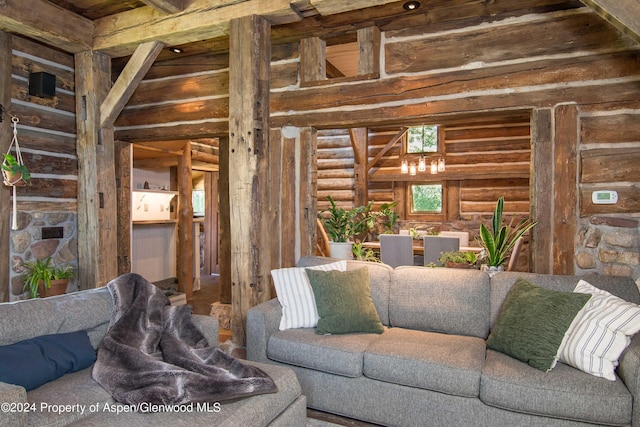 living room featuring beam ceiling and rustic walls