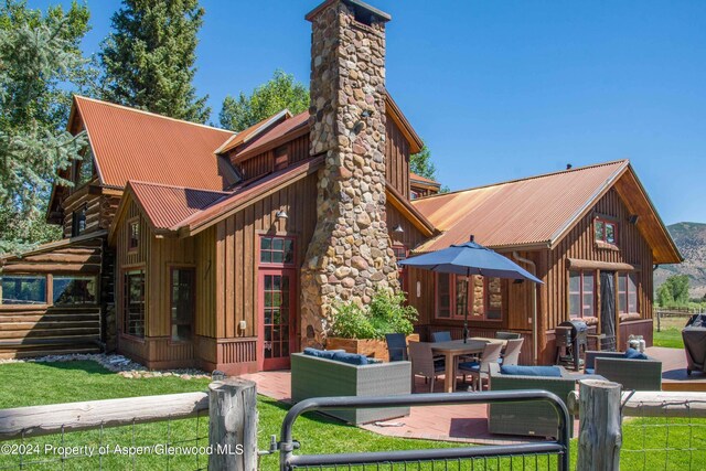 rear view of property featuring outdoor lounge area and a patio