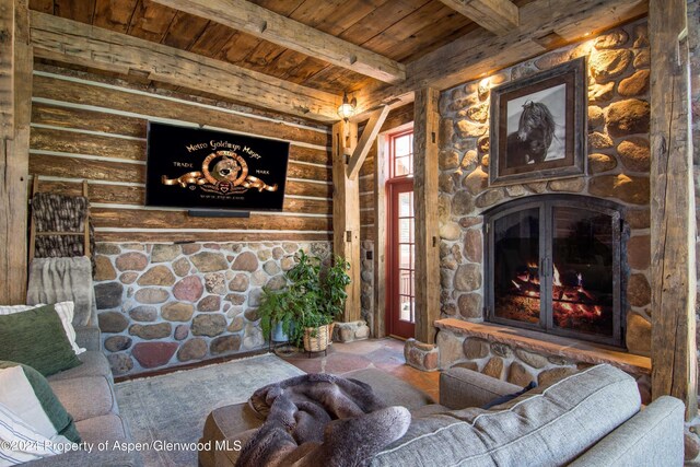 living room featuring beam ceiling, a fireplace, and wood ceiling