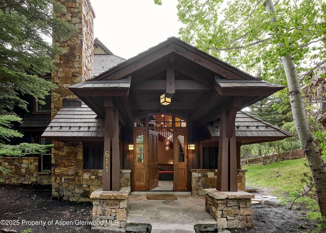 611 Oregon Trl, Aspen, CO 81611 - entrance to property featuring stone siding and a chimney