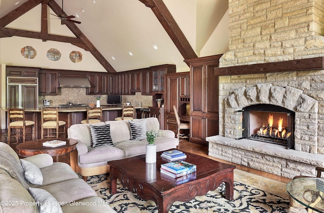 611 Oregon Trl, Aspen, CO 81611 - living area with high vaulted ceiling, ceiling fan, a fireplace, wood finished floors, and beam ceiling