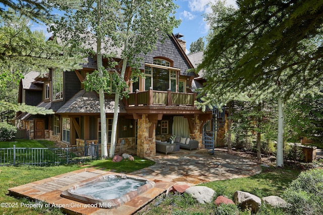 611 Oregon Trl, Aspen, CO 81611 - rear view of property with stone siding, a patio, an outdoor hot tub, and a chimney