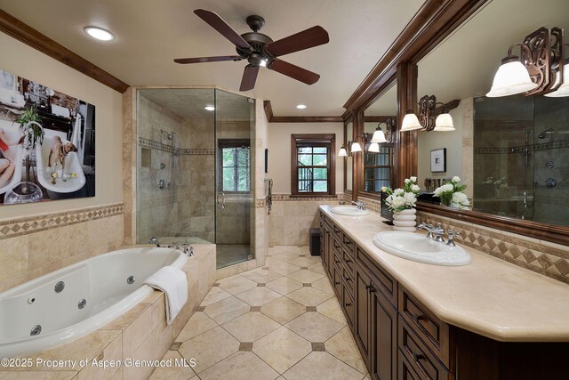 611 Oregon Trl, Aspen, CO 81611 - bathroom with tile walls, a shower stall, a jetted tub, ornamental molding, and double vanity
