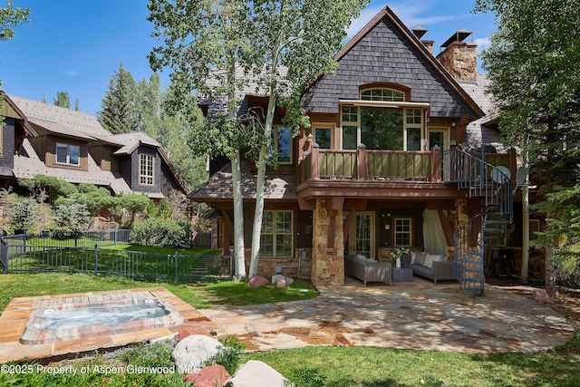 611 Oregon Trl, Aspen, CO 81611 - back of house with a patio, an outdoor hot tub, an outdoor hangout area, a chimney, and a deck