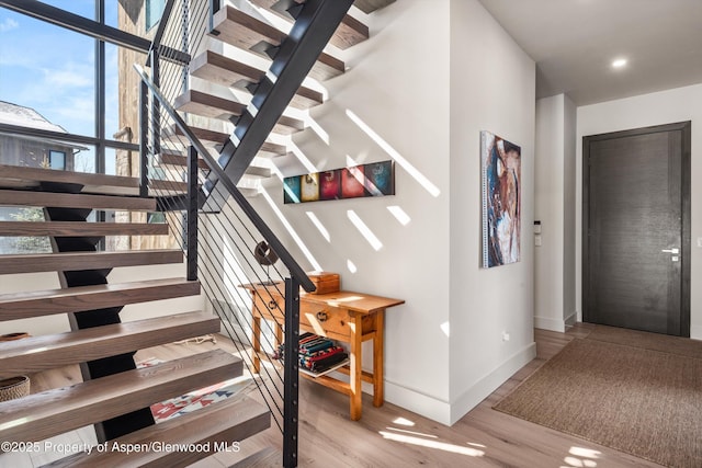 stairs featuring baseboards and wood finished floors