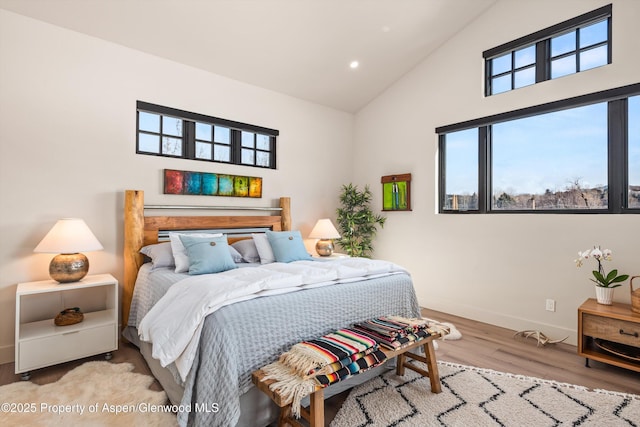 bedroom with high vaulted ceiling, recessed lighting, wood finished floors, and baseboards