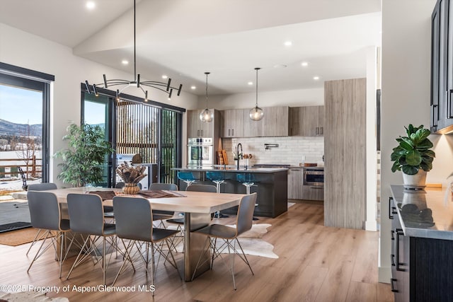 dining area featuring light wood-type flooring and recessed lighting