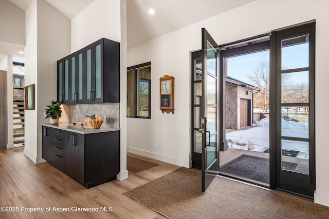 doorway to outside featuring light wood-type flooring and baseboards