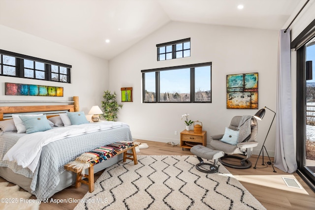 bedroom featuring recessed lighting, visible vents, vaulted ceiling, wood finished floors, and baseboards