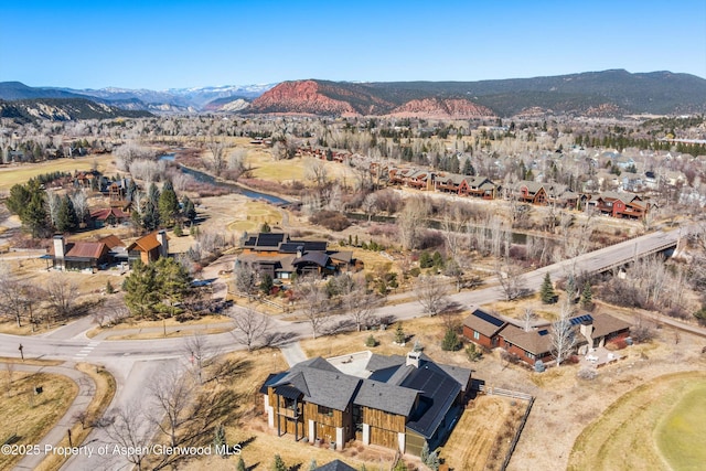 drone / aerial view featuring a residential view and a mountain view