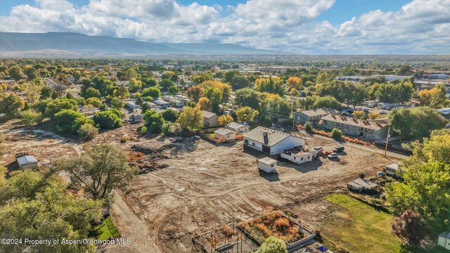 birds eye view of property with a mountain view