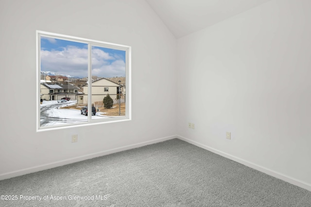 spare room with lofted ceiling and carpet floors