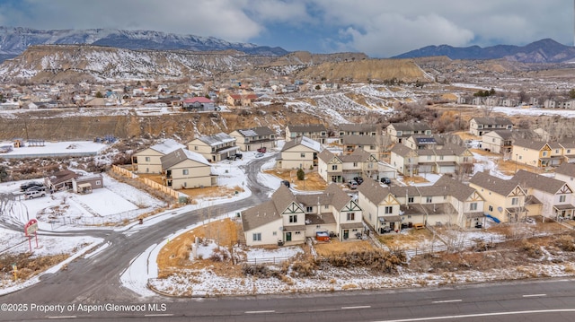 snowy aerial view with a mountain view