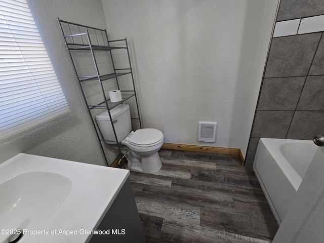 bathroom featuring hardwood / wood-style flooring, toilet, and sink