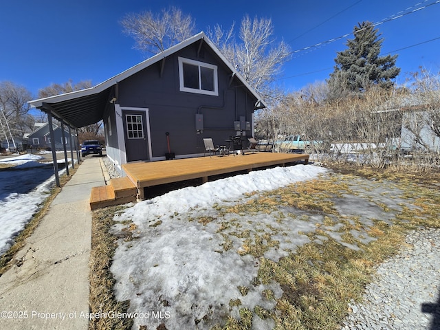 snow covered property with a deck