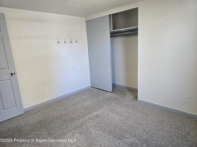 unfurnished bedroom with carpet floors and a closet