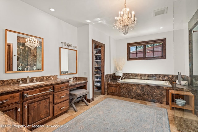 11 Pinon Ln, Carbondale, CO 81623 - bathroom with a chandelier, tile patterned floors, a garden tub, vanity, and recessed lighting