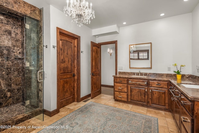 11 Pinon Ln, Carbondale, CO 81623 - bathroom featuring a shower stall, double vanity, recessed lighting, and a chandelier