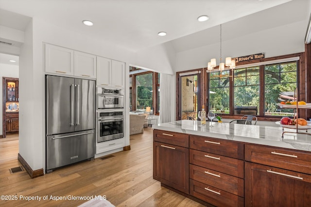 11 Pinon Ln, Carbondale, CO 81623 - kitchen featuring stainless steel appliances, white cabinetry, a chandelier, plenty of natural light, and recessed lighting
