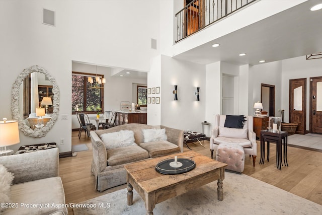 11 Pinon Ln, Carbondale, CO 81623 - living room with light wood-style floors, a chandelier, a towering ceiling, and recessed lighting