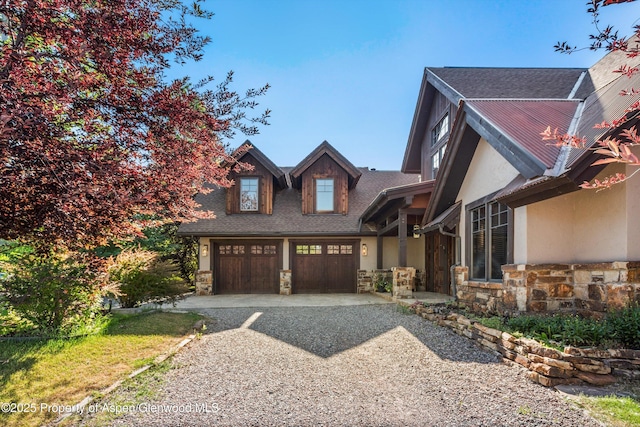 11 Pinon Ln, Carbondale, CO 81623 - craftsman-style home featuring stone siding, gravel driveway, a garage, stucco siding, and roof with shingles