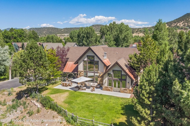 11 Pinon Ln, Carbondale, CO 81623 - back of property with stone siding, a patio area, stucco siding, an outdoor living space with a fire pit, and french doors