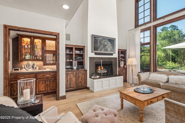11 Pinon Ln, Carbondale, CO 81623 - living room featuring a towering ceiling, light wood-type flooring, a fireplace, and recessed lighting