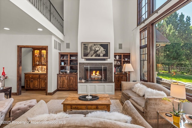11 Pinon Ln, Carbondale, CO 81623 - living area featuring a towering ceiling, plenty of natural light, wood finished floors, a premium fireplace, and recessed lighting