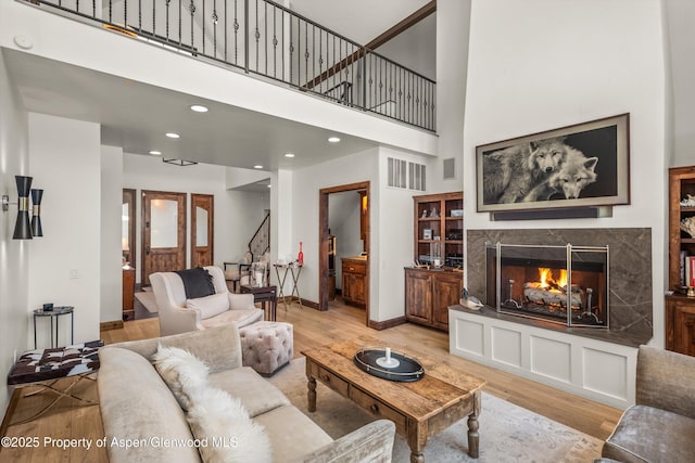 11 Pinon Ln, Carbondale, CO 81623 - living area with light wood-type flooring, a premium fireplace, stairway, a high ceiling, and recessed lighting