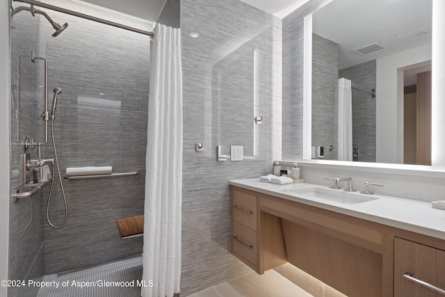 bathroom featuring a shower with shower curtain, vanity, and tile walls