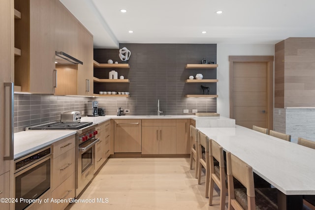 130 Wood Road 256 & 258, Snowmass Village, CO 81615 - kitchen featuring light brown cabinets, sink, stainless steel appliances, tasteful backsplash, and light hardwood / wood-style flooring