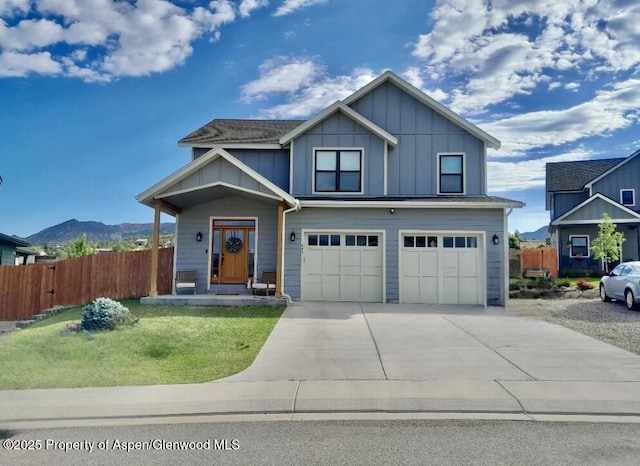 682 Eagles Nest Dr, Silt, CO 81652 - view of front of house featuring board and batten siding, concrete driveway, an attached garage, and a mountain view