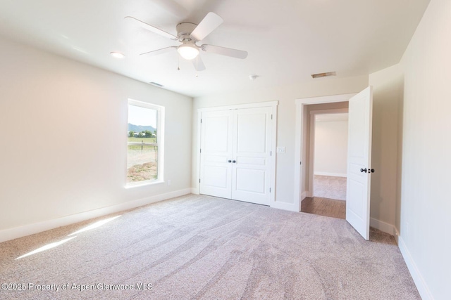 682 Eagles Nest Dr, Silt, CO 81652 - unfurnished bedroom featuring carpet floors, a closet, and ceiling fan
