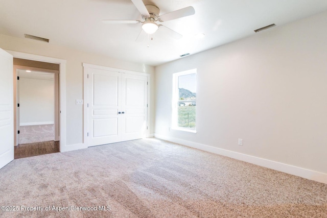 682 Eagles Nest Dr, Silt, CO 81652 - unfurnished bedroom with carpet floors, a closet, and a ceiling fan