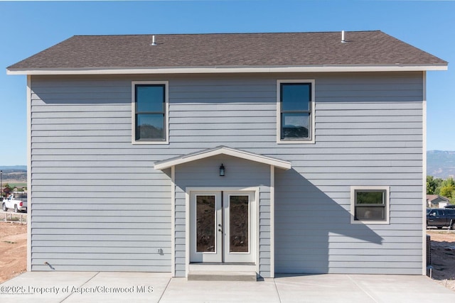 682 Eagles Nest Dr, Silt, CO 81652 - back of house featuring french doors, a patio, and roof with shingles