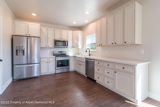 682 Eagles Nest Dr, Silt, CO 81652 - kitchen featuring appliances with stainless steel finishes, dark wood finished floors, light countertops, recessed lighting, and white cabinets