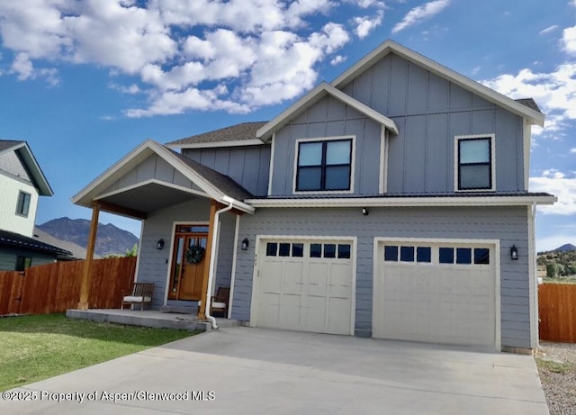 682 Eagles Nest Dr, Silt, CO 81652 - view of front of property featuring a garage, board and batten siding, concrete driveway, and a mountain view