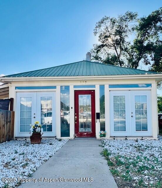 337 W Ave, Rifle, CO 81650 - entrance to property featuring french doors, a chimney, and a metal roof