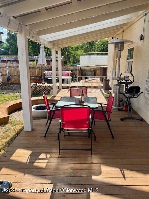 337 W Ave, Rifle, CO 81650 - wooden terrace featuring outdoor dining space, a fenced backyard, and an outdoor hangout area