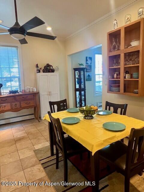 337 W Ave, Rifle, CO 81650 - dining space with crown molding, a ceiling fan, light tile patterned floors, and baseboard heating