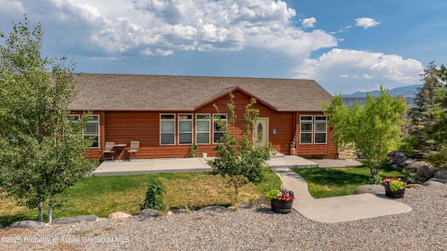 22 Booms Pl, Rifle, CO 81650 - view of front of home featuring a shingled roof, a patio, and a front yard