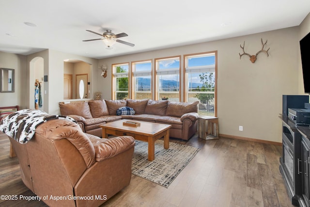 22 Booms Pl, Rifle, CO 81650 - living area featuring a ceiling fan, light wood finished floors, and arched walkways