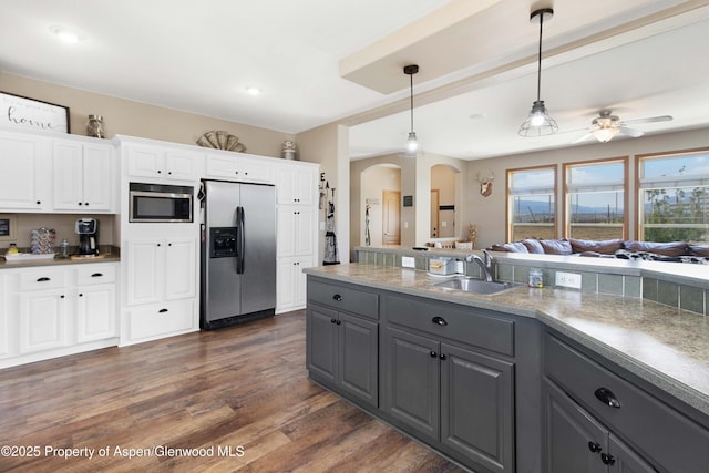 22 Booms Pl, Rifle, CO 81650 - kitchen with gray cabinets, appliances with stainless steel finishes, arched walkways, white cabinetry, and hanging light fixtures