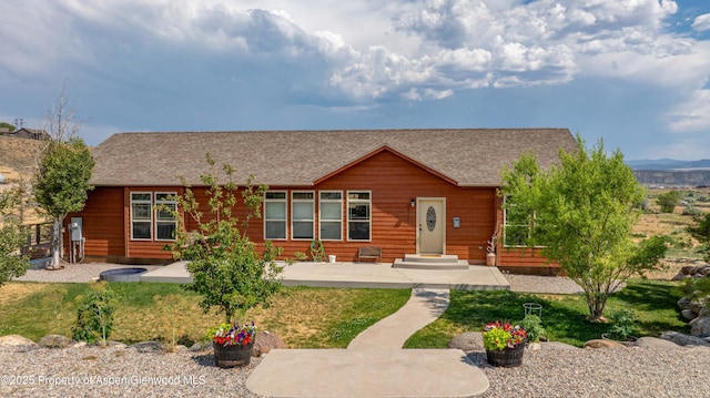22 Booms Pl, Rifle, CO 81650 - rustic home with roof with shingles, a front yard, and a patio