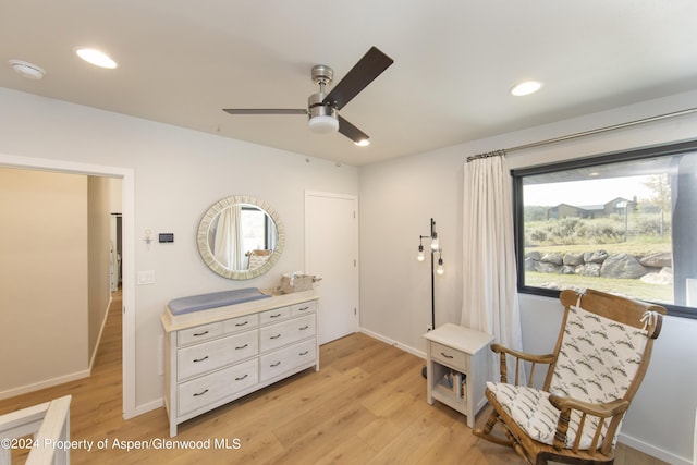 sitting room with ceiling fan and light hardwood / wood-style flooring