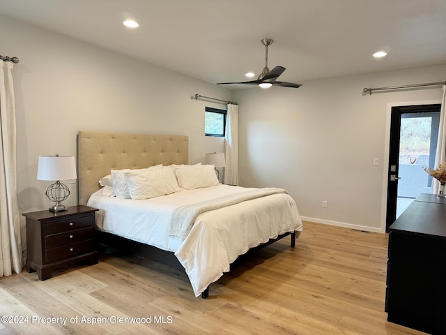 bedroom with ceiling fan, access to exterior, light wood-type flooring, and multiple windows