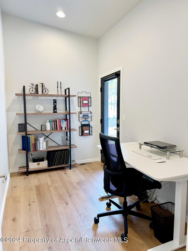 office with hardwood / wood-style flooring