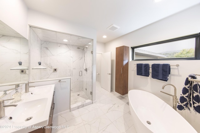 bathroom featuring vanity and shower with separate bathtub